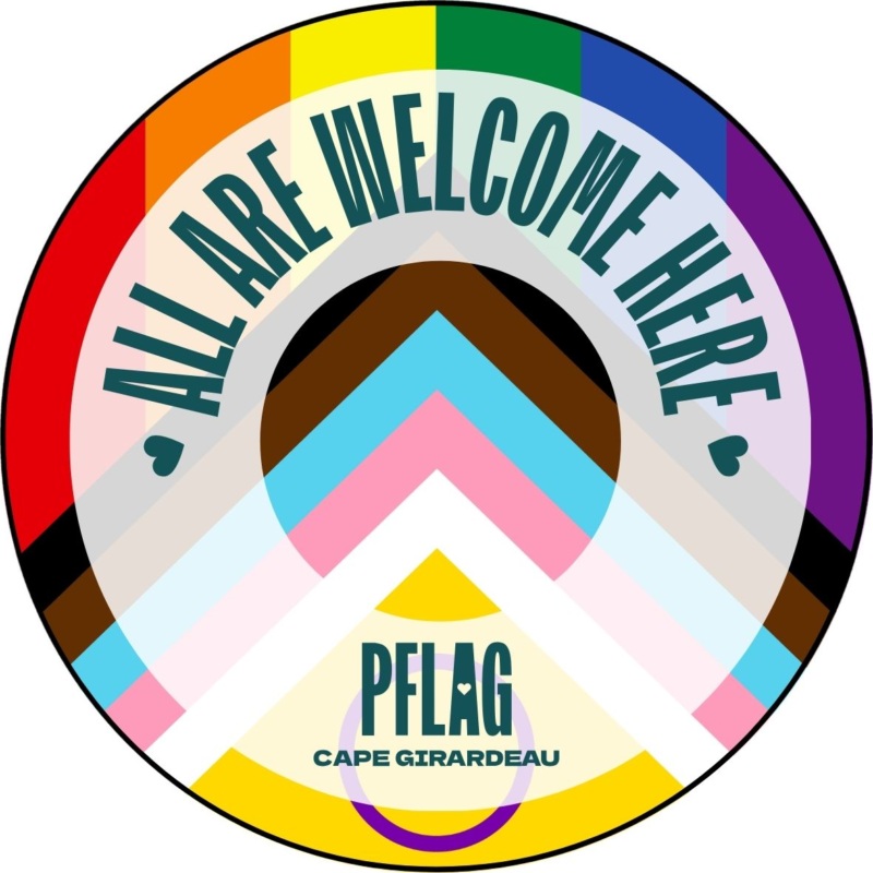 an image of the logo which is a circle with the words All Are Welcome Here and also Pflag Cape Girardeau. The interior of the circle has the progressive pride flag.